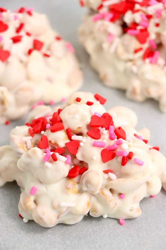 white chocolate peanut clusters with red & pink sprinkles.