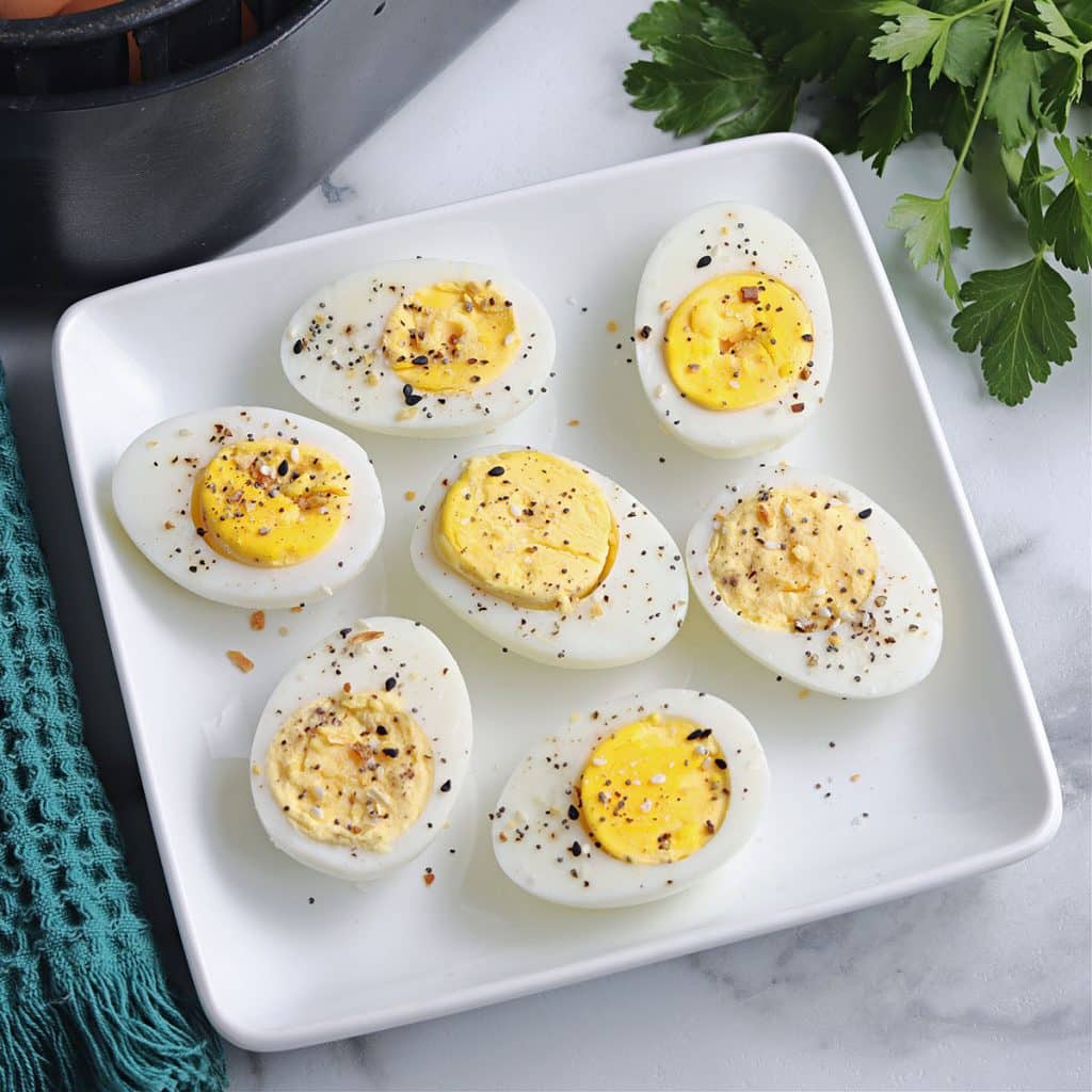 plate of hard boiled eggs sprinkled with pepper.