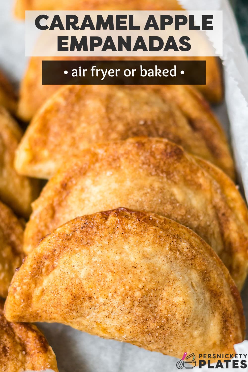 Air Fryer Caramel Apple Empanadas are a throwback Taco Bell copycat made even better! Store-bought crust with an apple pie filling and melted caramel candies comes together quickly, then air fried (or baked) until golden on the outside and thick and syrupy on the inside. Topped with cinnamon sugar, these easy 30-minute dessert empanadas are the best! | www.persnicketyplates.com