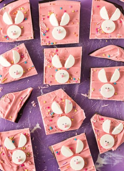 overhead shot of easter bunny candy bark on a purple cutting board.