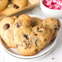white plate with stack of 3 heart shaped chocolate chip cookies.