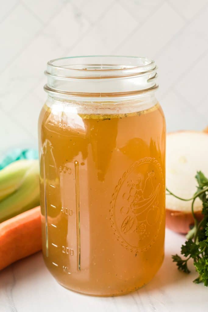 mason jar filled with homemade chicken stock.