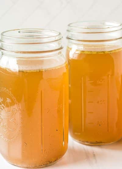 two mason jars filled with homemade chicken stock.