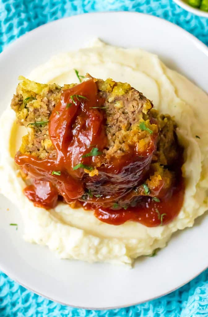 overhead shot of meatloaf with mashed potatoes on a plate.