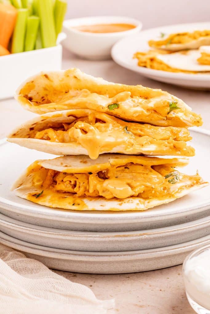 stack of buffalo chicken quesadillas on a white plate.