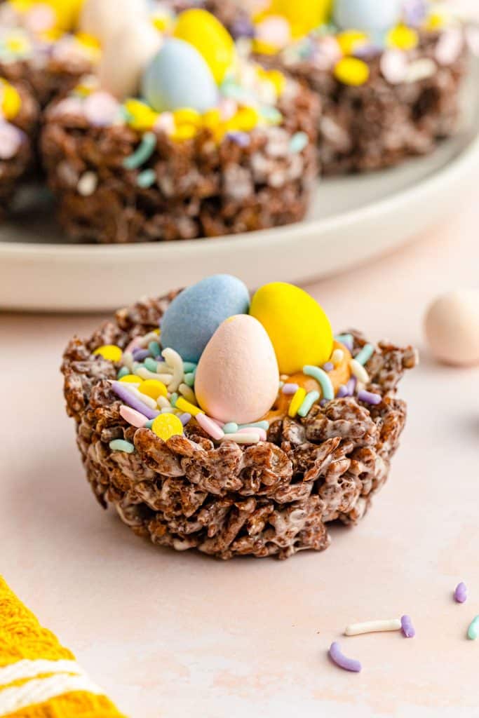 side view of a chocolate bird nest cookie with mini eggs and sprinkles.