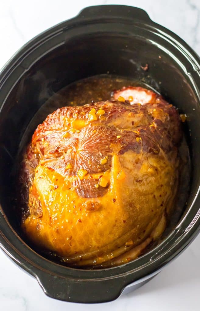 overhead shot of a ham in a slow cooker.