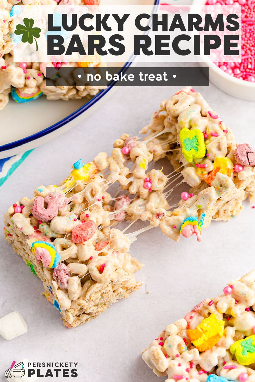 Lucky charms treats are a no bake dessert made with 15 minutes of prep time using everyone's favorite cereal! They're loaded with colorful lucky charms and melty marshmallows set into festive, chewy, gooey squares that are perfect for all your St. Patrick's Day dessert trays! | www.persnicketyplates.com