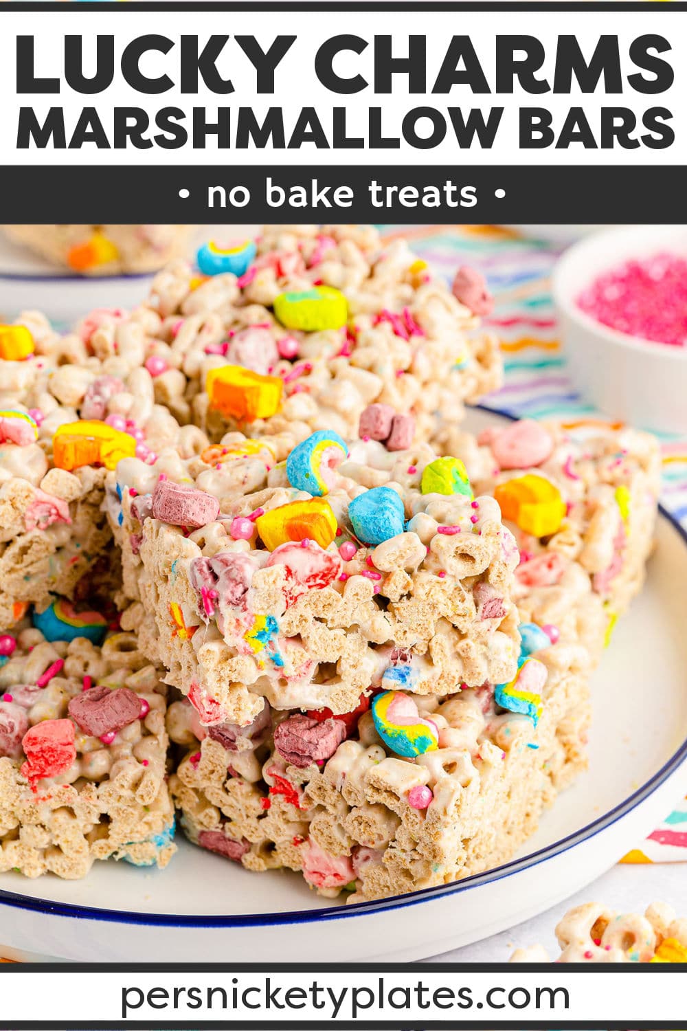 Lucky charms treats are a no bake dessert made with 15 minutes of prep time using everyone's favorite cereal! They're loaded with colorful lucky charms and melty marshmallows set into festive, chewy, gooey squares that are perfect for all your St. Patrick's Day dessert trays! | www.persnicketyplates.com
