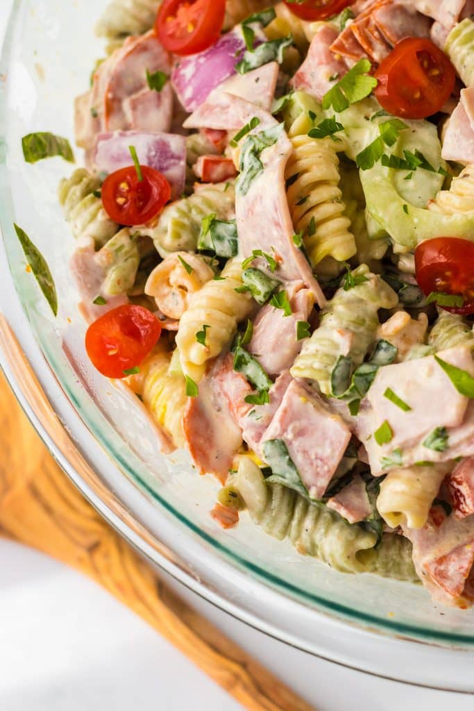 overhead shot of italian sub pasta salad in a glass mixing bowl.