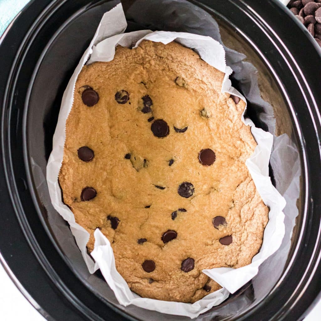 overhead shot of a chocolate chip cookie in a slow cooker.