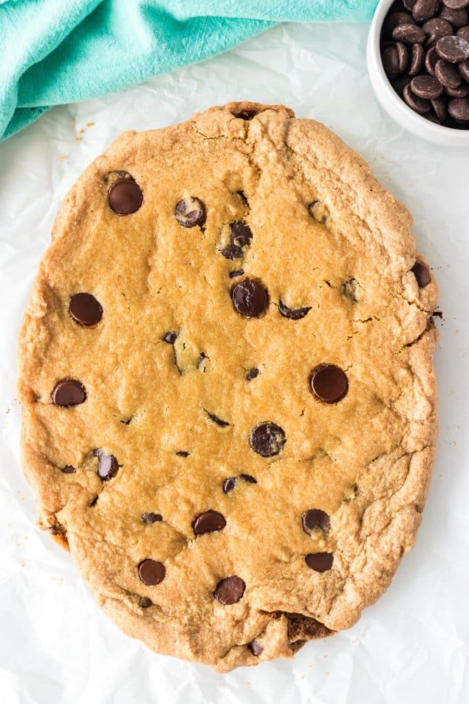 overhead shot of a large oval chocolate chip cookie.