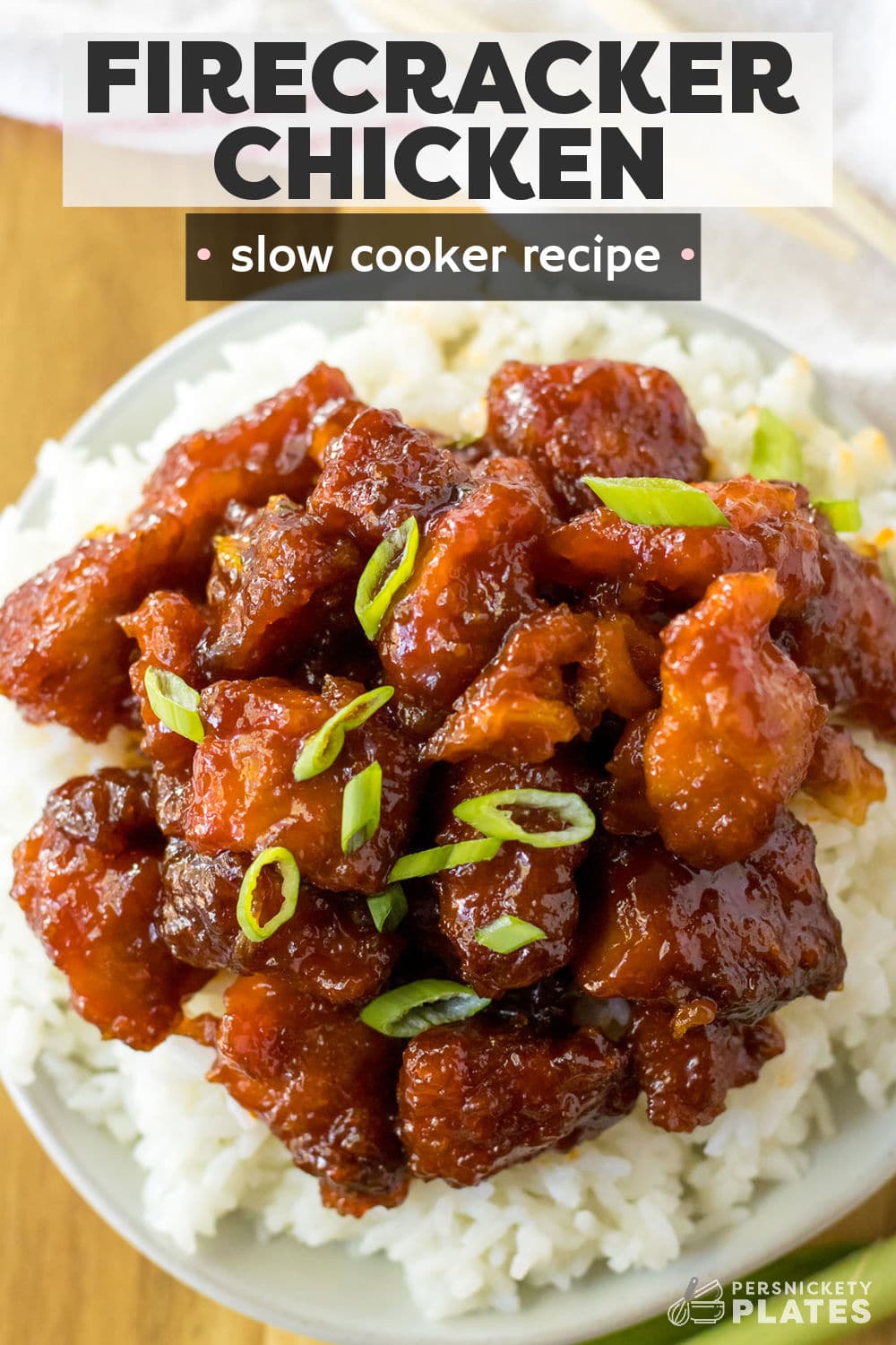 Slow cooker firecracker chicken is an Asian-inspired dish jam packed with flavor and so easy to make! Cubes of juicy chicken bites browned and then slow cooked in a sweet, spicy, and tangy sauce. This dish is made right in the crockpot so you can set it and forget it, allowing the flavors to meld together and the chicken to become perfectly juicy and tender. | www.persnicketyplates.com