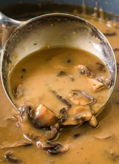 ladle scooping mushroom gravy.