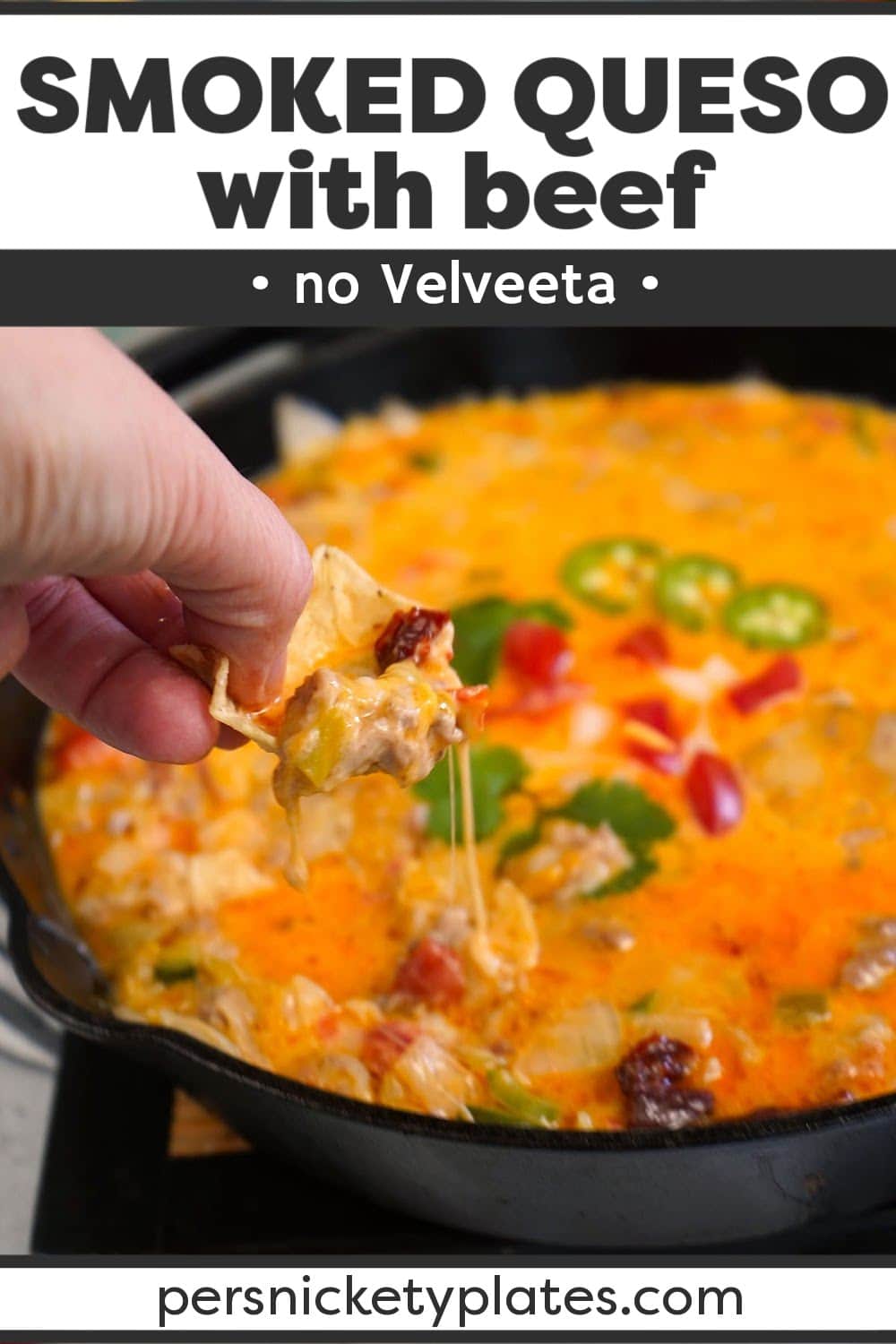 This smoked queso recipe with beef is made with two kinds of freshly grated real cheese and no Velveeta! Loads of ground beef, tomatoes, onions, and three kinds of peppers for heat are cooked low and slow in a flavor-infused smoker giving this ultimate queso dip tons of Mexican-inspired flavor. | www.persnicketyplates.com