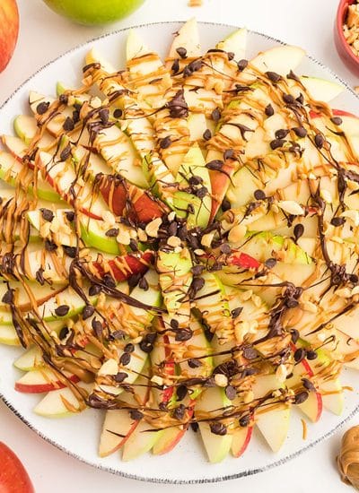 overhead shot of apple nachos drizzled with peanut butter and chocolate.