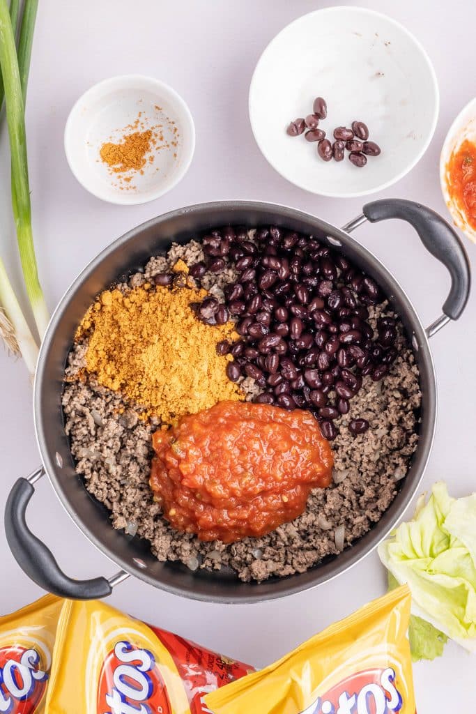 skillet filled with ground beef, black beans, cheese, and salsa.