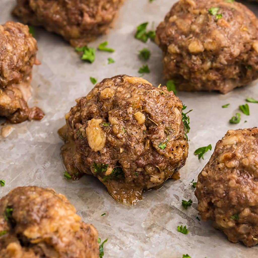 baked meatballs on a cookie sheet.