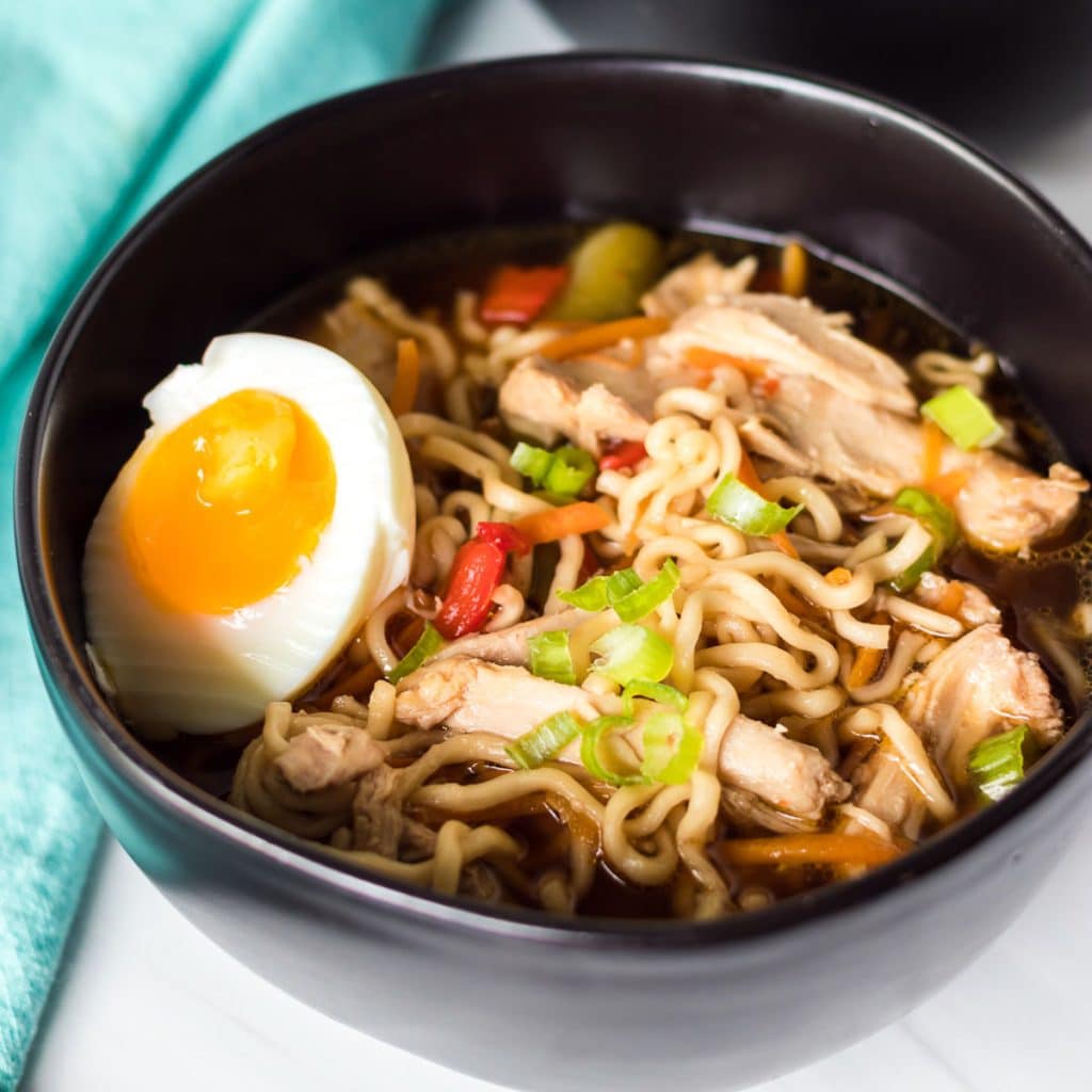 bowl of chicken ramen topped with a soft boiled egg.