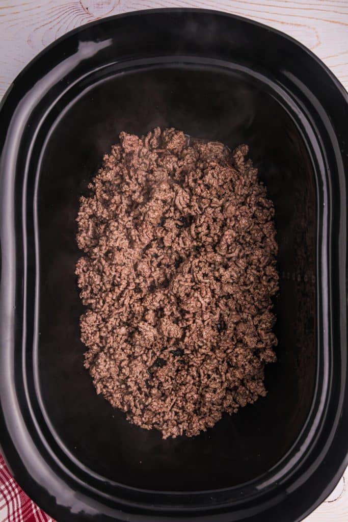 overhead shot of cooked ground beef in a crockpot.