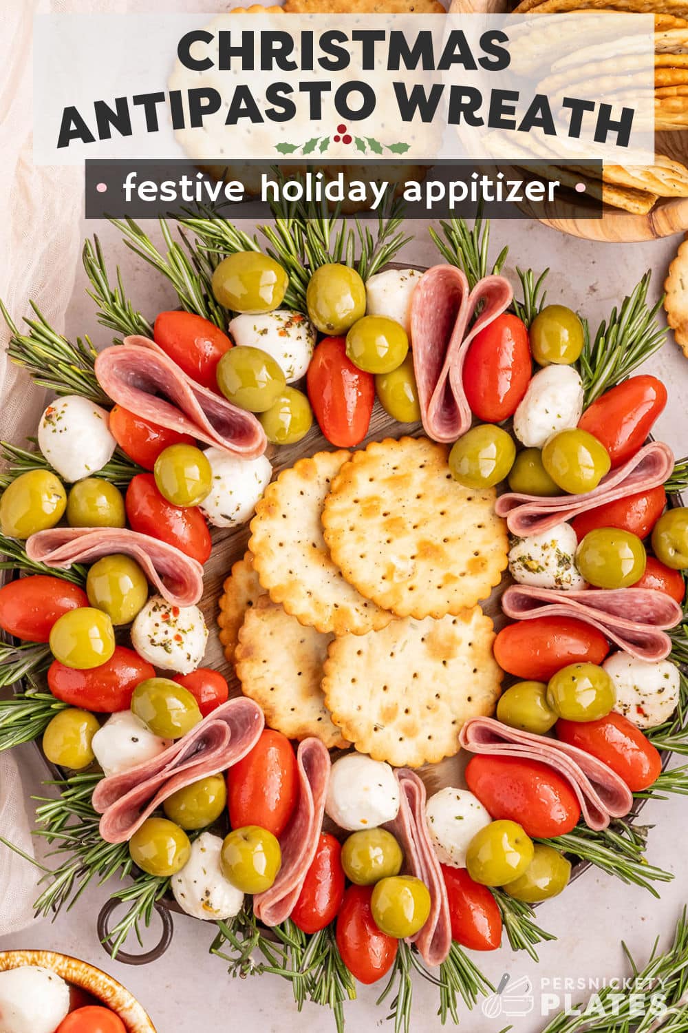 Learn to make this adorably festive and easy Christmas Antipasto Wreath with salami, mozzarella cheese, briny olives, and fresh sprigs of rosemary! This fun and tasty platter is as customizable as it gets and comes together in just minutes. The antipasto skewers are always a huge hit and the perfect way to keep your party guests satisfied before the main meal! | www.persnicketyplates.com