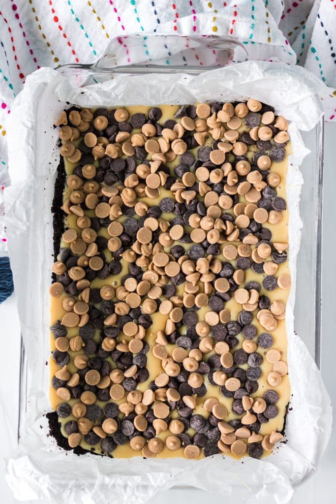 overhead shot of chocolate and peanut butter chips sprinkled in a baking dish.