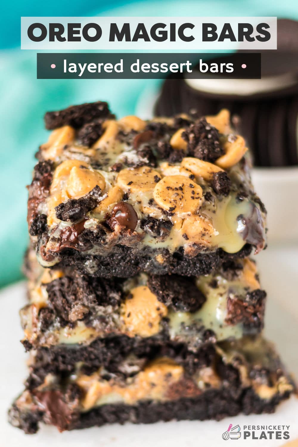 Oreo magic bars are crave-worthy and irresistible dessert bars that are made with an Oreo cookie crust, melty chocolate and peanut butter chips then topped with Oreo cookie pieces. It's all held together with sweetened condensed milk that makes these bars ooey, gooey, and always a hit. They are easy to make with just 5 ingredients and it's all baked in under 30 minutes! | www.persnicketyplates.com