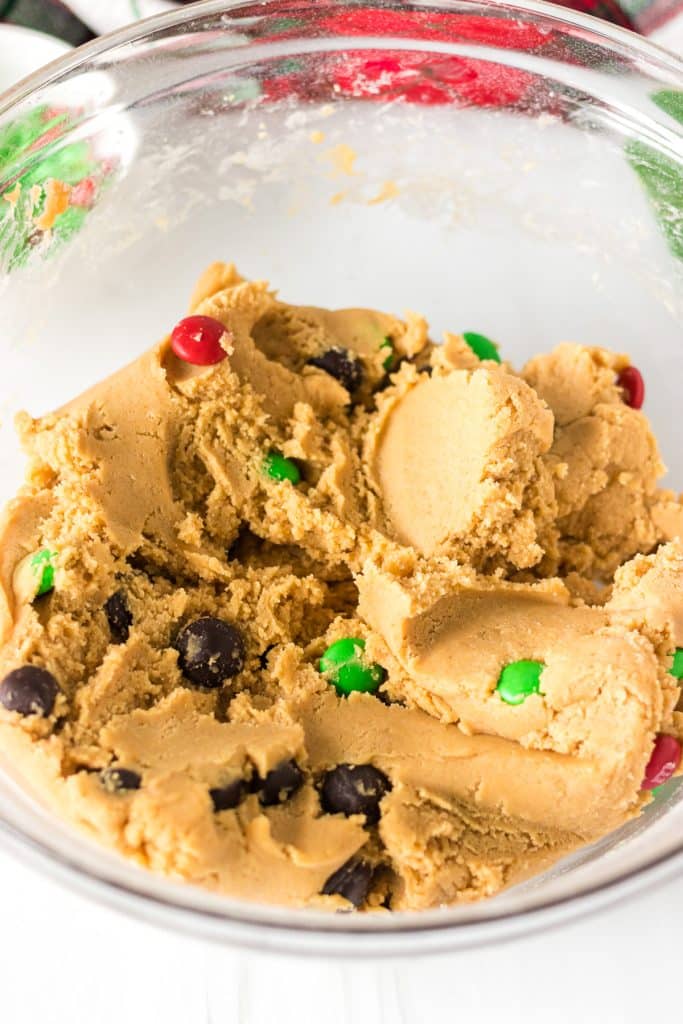 chocolate chip cookie dough in a glass mixing bowl.