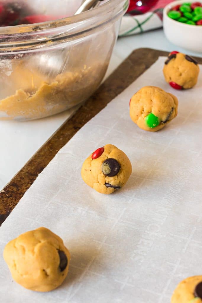 cookie dough balls on a baking sheet.