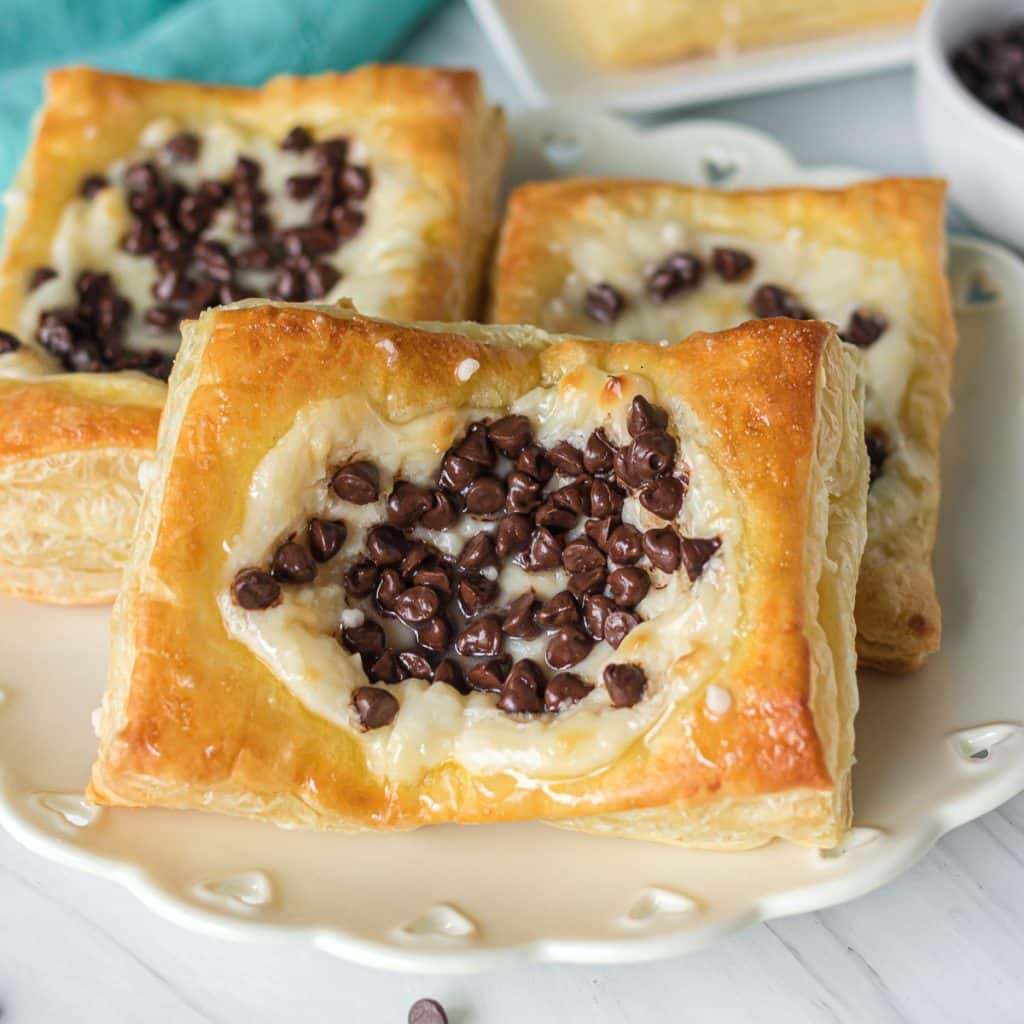 chocolate chip cream cheese danishes on a white plate.