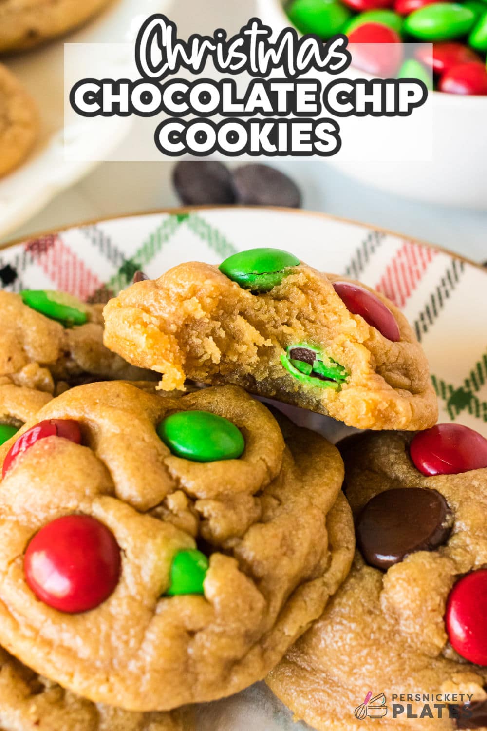 Chocolate Chip Cookies all dressed up for the holiday season! The classic chocolate chip cookie recipe get an upgrade with red and green m&m candies and a secret ingredient to make them extra soft and thick. | www.persnicketyplates.com