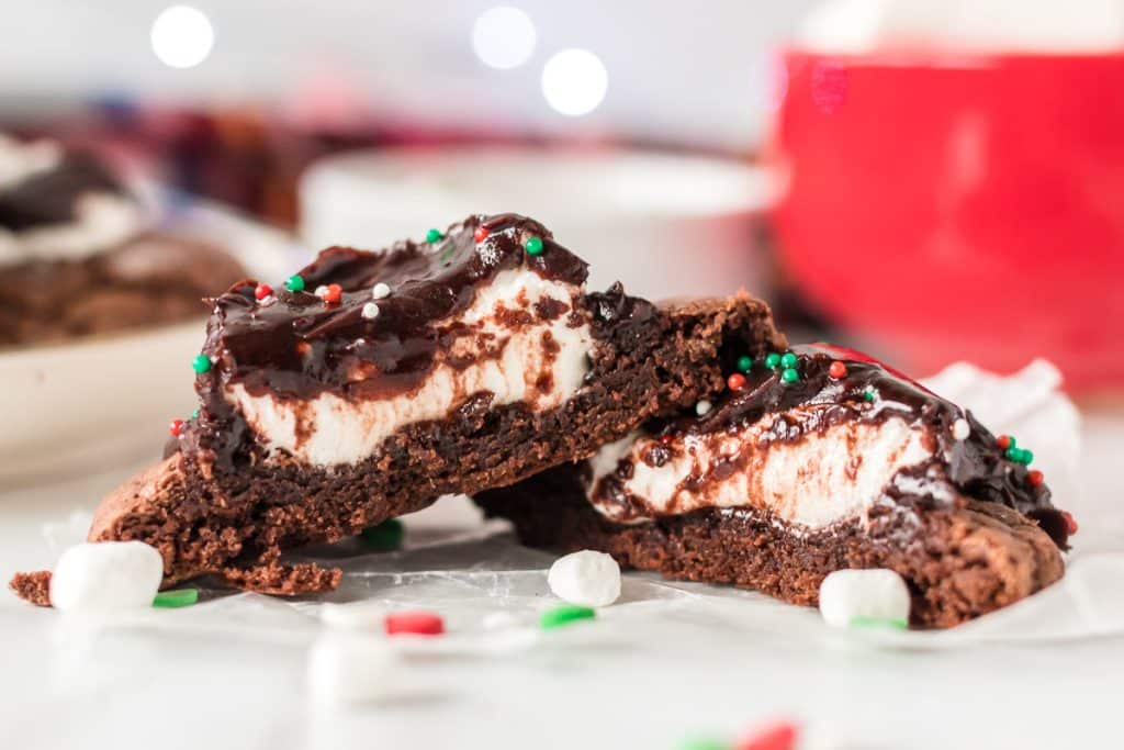 sliced hot chocolate cookie with marshmallow center and chocolate frosting.