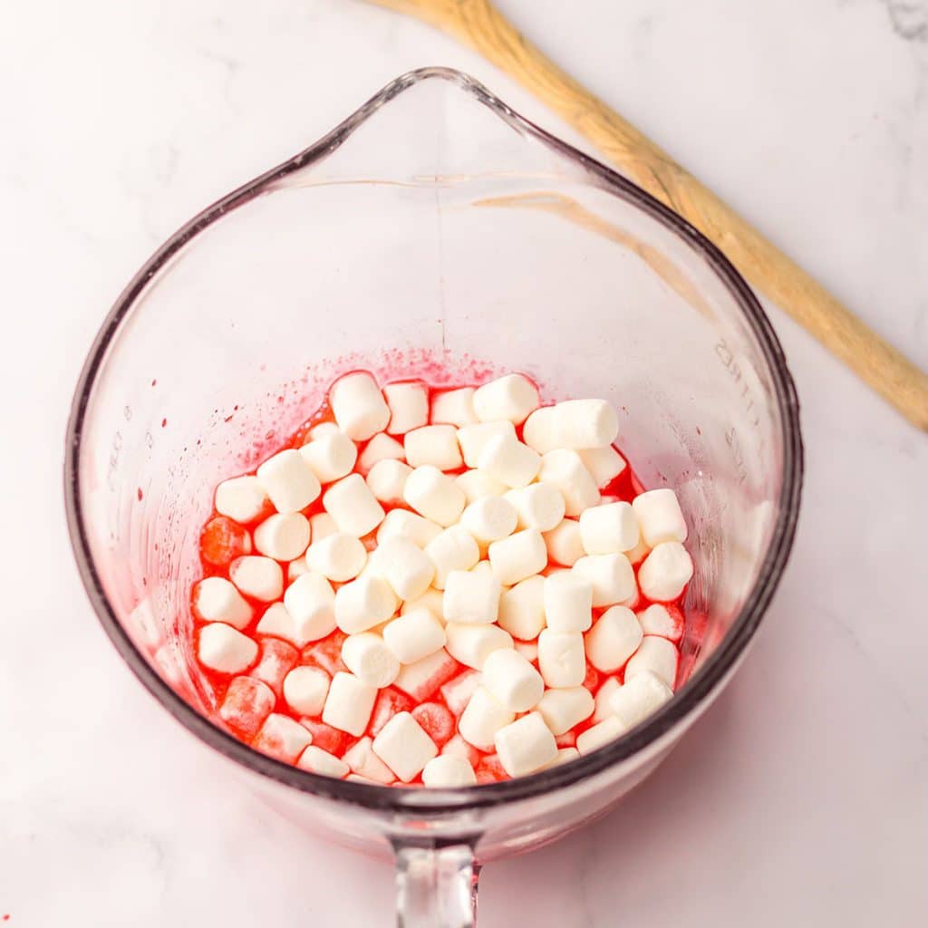 overhead shot of mini marshmallows in a measuring cup.