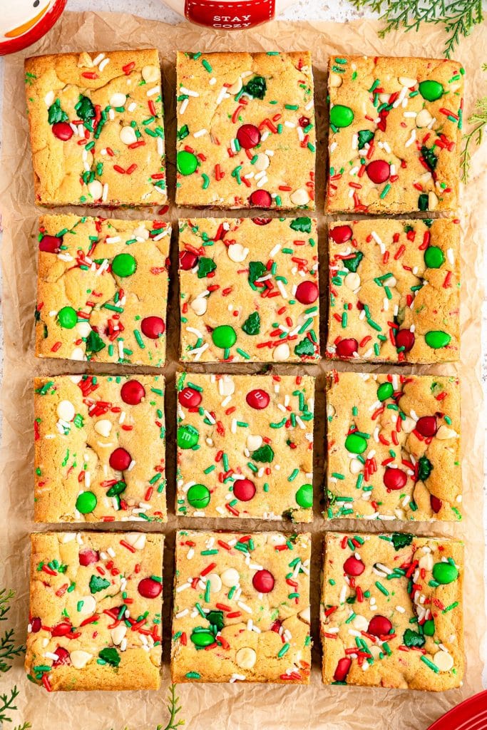 overhead shot of sliced christmas cookie bars with red & green sprinkles and M&Ms.