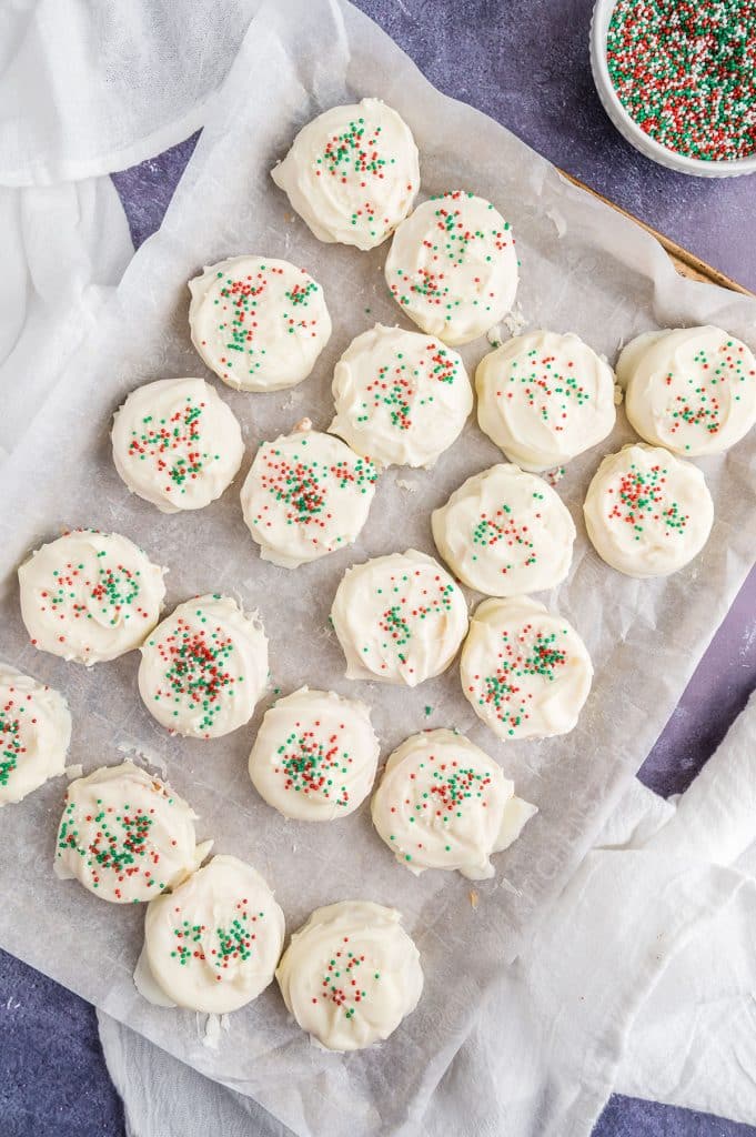 baking tray filled with ritz cracker cookies topped with christmas sprinkles.