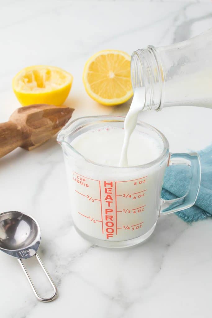 milk pouring into a measuring cup.