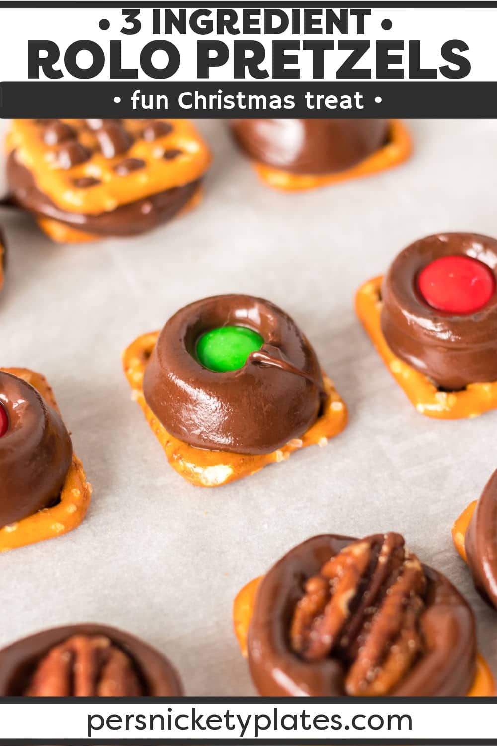 Rolo pretzels are a bite-size treat that requires only 3 ingredients and no baking! Depending on whether you top them with another pretzel, a pecan, or a holiday M&M, you have the choice between 3 different versions. I, for one, think you should make all 3. I can never decide on my favorite variation, so I make them all! | www.persnicketyplates.com