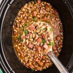 ladle lifting black eyed peas from a crockpot.