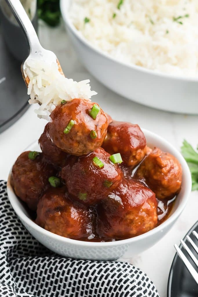 bowl of meatballs with a fork of rice.