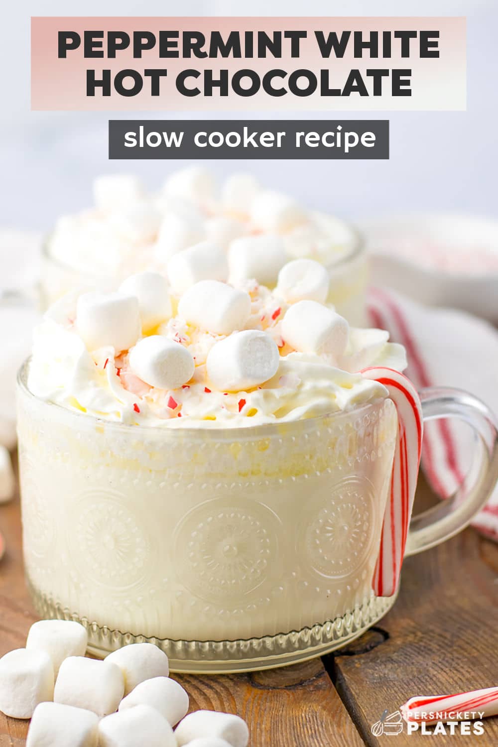 The ultimate winter drink is here! Make a big batch of this peppermint white hot chocolate recipe right in your slow cooker so everyone can have a mug or two. The rich creamy white hot chocolate with a wintry peppermint kick will have you and your loved ones feeling all the warm fuzzies from the inside out. | www.persnicketyplates.com