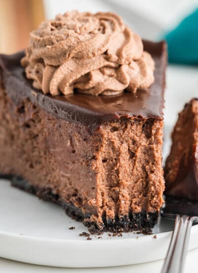 slice of triple chocolate cheesecake with a bite missing.