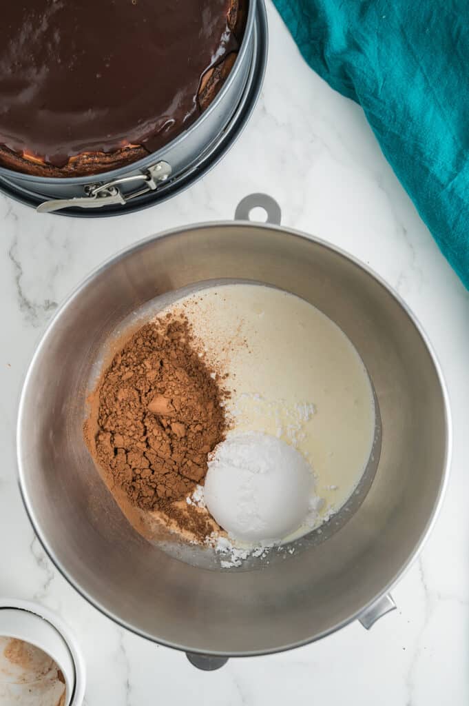 cocoa powder, cream, and sugar in a mixing bowl.