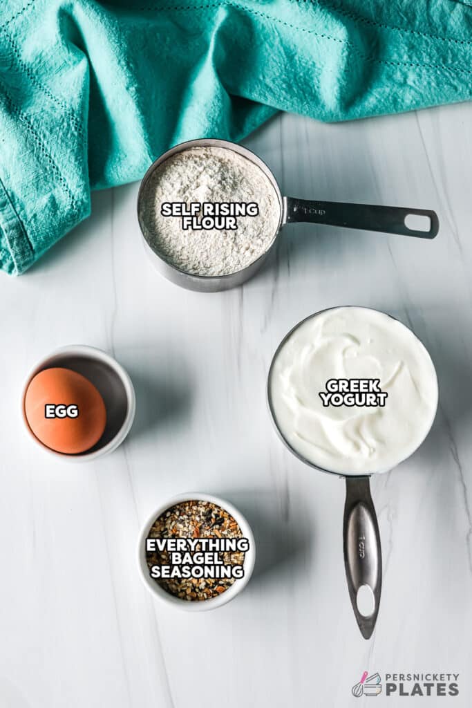 labeled ingredients laid out to make greek yogurt bagels.