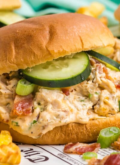 bacon ranch chicken sandwich topped with cucumbers.