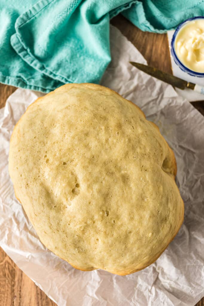 overhead shot of a round loaf of bread made in a crockpot.