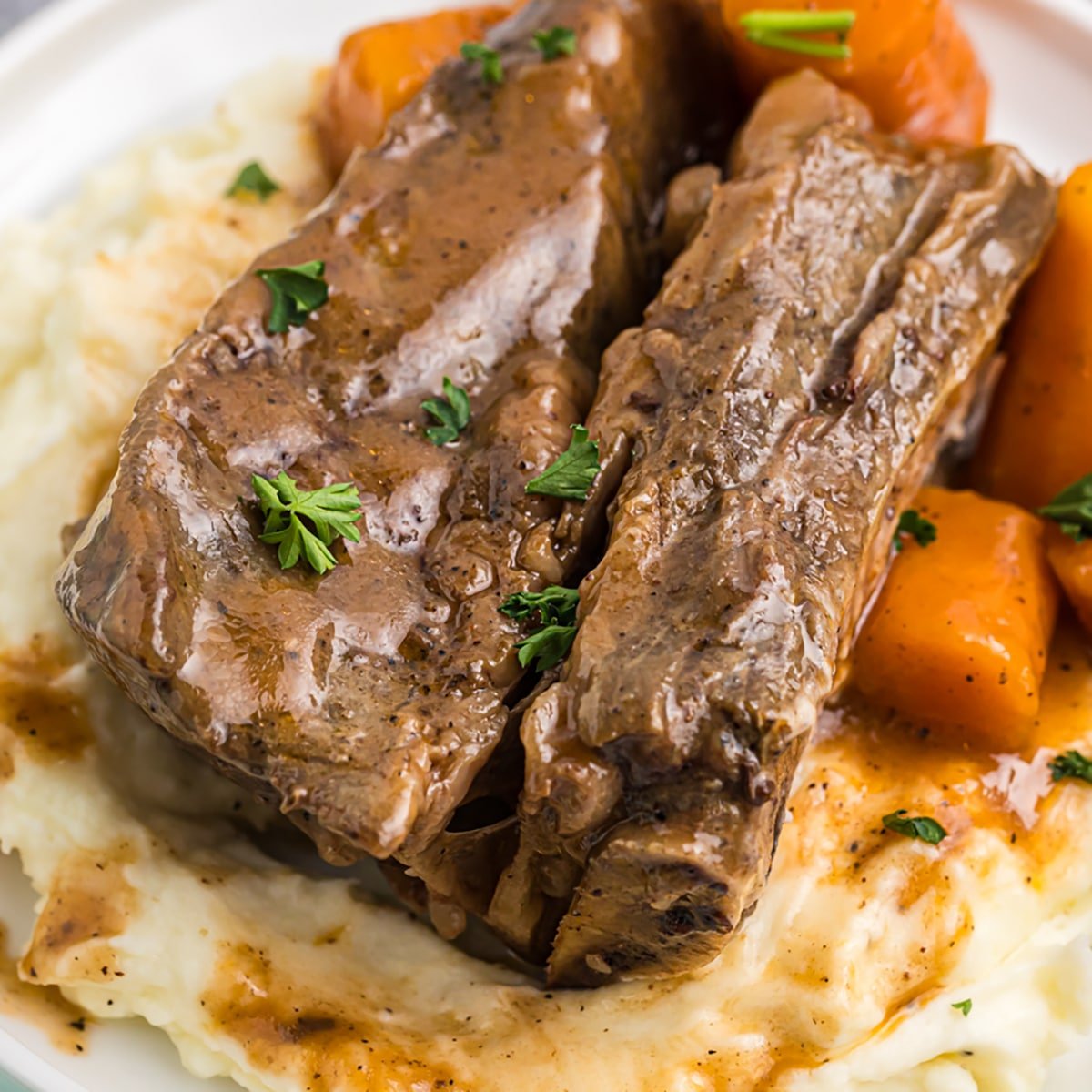 short ribs on mashed potatoes and carrots.