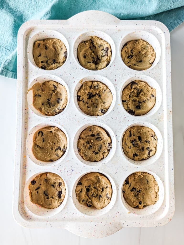 cookie dough pressed into a cupcake pan.
