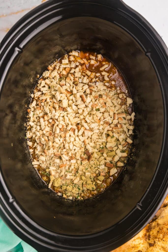 overhead shot of stuffing mix in a slow cooker.