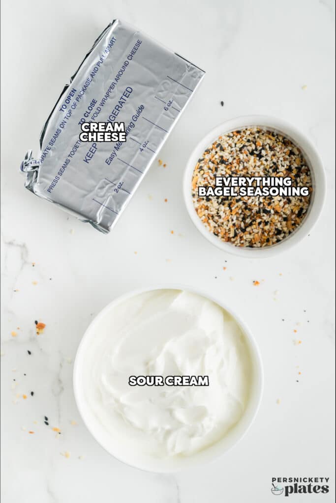 overhead shot of cream cheese, sour cream, and everything bagel seasoning.