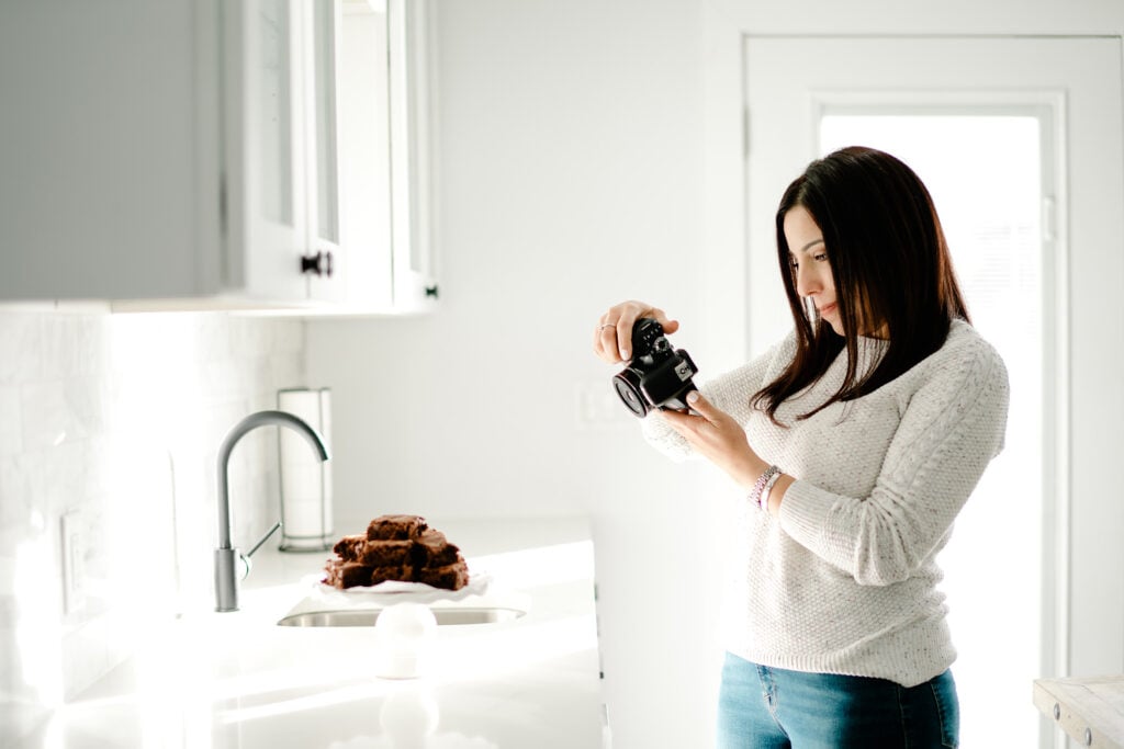 woman photographing a plate of brownies.
